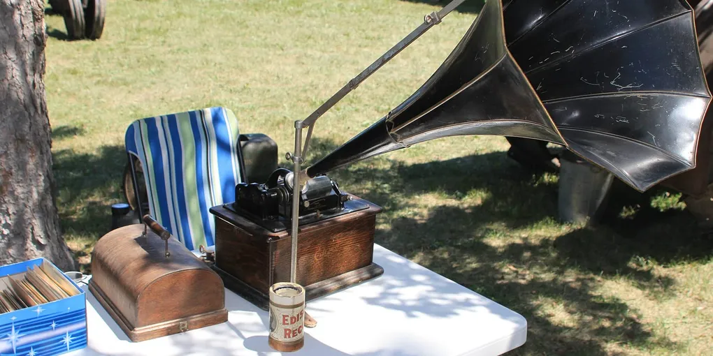 An antique wax-cylinder phonograph with a wooden base and large black horn