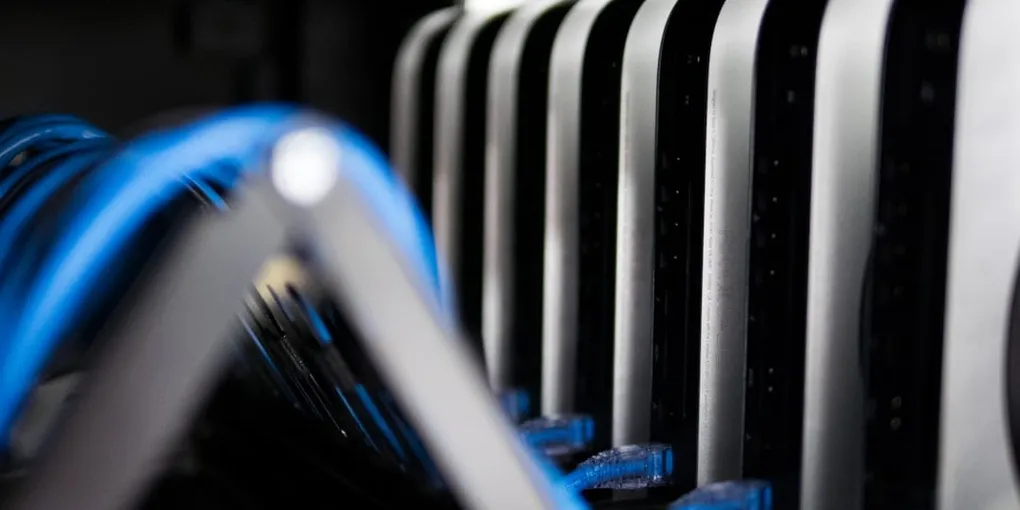 Rows of compact computers and network cables mounted in a rack